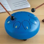 Eight Note Steel Tongue Drum Kit - Metal African musical Instrument - 6" steel tongue drum, songbook with instructions, set of stickers, 2 wooden mallets, 1 mallet holder, and a carrying bag.