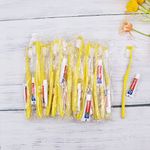 Disposable Toothbrush with Toothpaste Pack of 150,Yellow Hollow Hotel Toothbrush Set Individually Wrapped Manual Travel Toothbrush Kit for Adults,Kids,Hotel,Homeless,Nursing Home,Charity