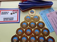 DWL MAN OF THE MATCH FOOTBALL MEDALS SET OF 15-50MM METAL WITH RIBBONS AND CERTIFICATES