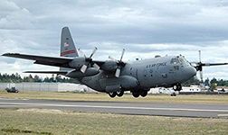 A C-130 Hercules lands at McChord Air Force Base, Washington Poster Print by Stocktrek Images (17 x 11)