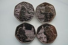 4 Paddington coins in sleeves. Uncirculated quality