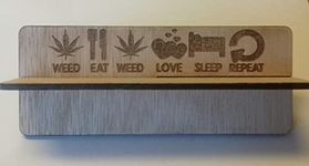 Wooden rolling up stand with slogan on 'Weed eat weed love sleep repeat'