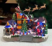 Christmas Village Centerpiece Decor, Santa Riding in Sleigh, with Christmas Tree and Village Buildings, Featuring LED Lights, Christmas Music, and Animation Power Adapter Included