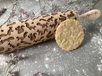 Rolling pin Funny Squirrels pattern. Wooden embossing rolling pin with Funny Squirrels pattern. Embossed cookies. Pottery.