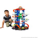 Hot Wheels City Ultimate Garage Playset with Multi-Level Racetrack, 91 cm Tall Moving T-Rex Dinosaur, Parks 100 Cars, Includes 2 Toy Cars, Toys for Ages 5 to 8, One Pack, GJL14